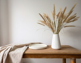 modern white ceramic vase with dry lagurus ovatus grass and marble tray on vintage wooden bench table blurred beige linen blanket in front scandinavian interior empty white wall copy space mock