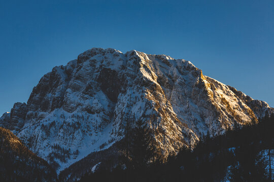 dettagli del Monte Cima del Lago, vicino al paese di Cave del Predil, regione Friuli Venezia Giulia, Italia, al tramonto, in inverno, con cielo sereno