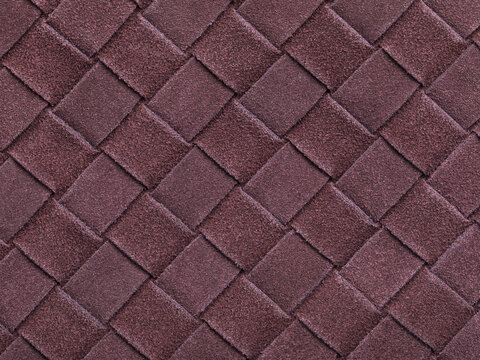 Brown texture of interwoven suede leather forming a square abstract shape