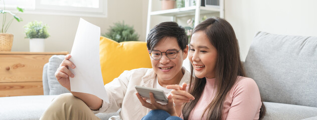 Happy asian family young couple love hand holding piggy bank to save and model house for saving...