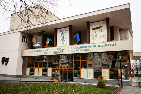Anton Chekhov russian State Theatre building in Chisinau Moldova with posters and flags on a glass storefront
