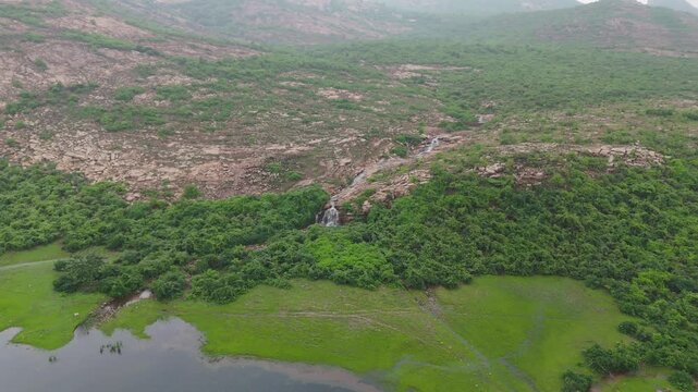 Aerial Hills and Green Valley, Drone View of Rocky Hills, Lush Green Valley Landscape, Scenic Hillside Wetland Aerial, Natural Mountain Valley View