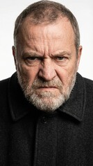 Obraz premium A striking portrait of an older, serious man with a grey beard, displaying an intensely ANGRY and scowling facial expression, conveying deep frustration and powerful displeasure