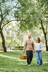 Fototapeta premium Couple enjoys a serene spring afternoon walk in a lush green park