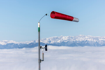 A&nbsp;windsock&nbsp;also known as&nbsp;wind cone&nbsp;or&nbsp;wind sleeve in front of mountain range Hochschwab in Styria, Austr