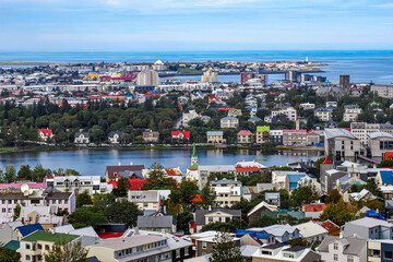 Panoramic view to the old town of Reykjav&iacute;k - City of Sagas. Colorful buildings, churches and lake Tj&ouml;rnin. Beautiful capital and largest city of Iceland. Fr&iacute;kirkjuvegur district, Reykjanes Peninsula.