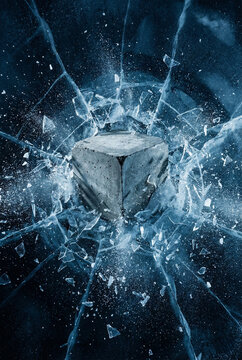 Vertical high-speed photograph of a rough concrete podium crashing into and shattering a thick ice sheet, with dramatic blue lighting and exploding shards