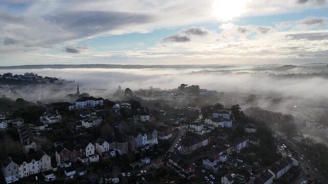 Aerial view over Torquay with unusual low clouds hanging over the town