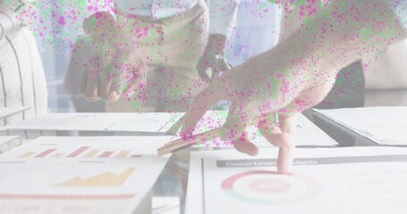 Pointing hands and team reviewing reports on glass table, in shirts holding pen over circular chart