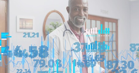 Reviewing physician holding tablet with blue overlays in medical office, lab coat and stethoscope