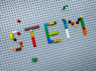 Obraz premium Word STEM made of colorful plastic LEGO bricks on a gray baseplate, representing science and technology education concept: 25.05.2024- Ljubljana, Slovenia
