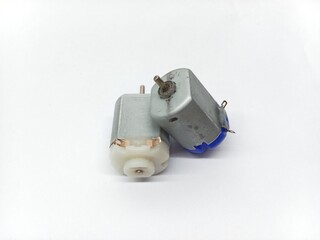 Small high-speed DC electric motor for miniature toy racing car isolated on white background