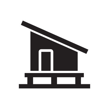 Black silhouette of a modern tiny house on stilts with a slanted roof, minimalist architectural icon for sustainable property and small living.