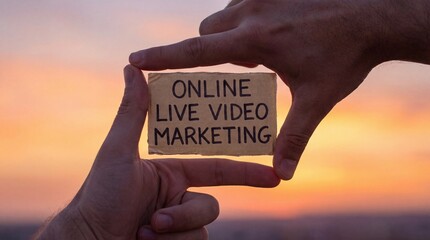 Hands Making Frame Around Online Live Video Marketing Sign Against Sunset Sky, Digital Content Creation and Promotion Concept