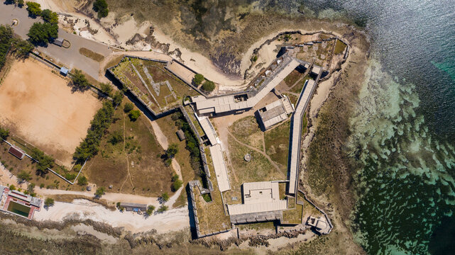 Aerial view of the Fortaleza de Sao Sebastiao, a stone fortress standing resolute against the azure waters, its weathered walls whispering tales of the past, Ilha de Mocambique, Nampula, Mozambique.