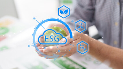 Person holding green globe with ESG environmental social and governance icons for sustainable business development corporate responsibility and clean energy investment strategy