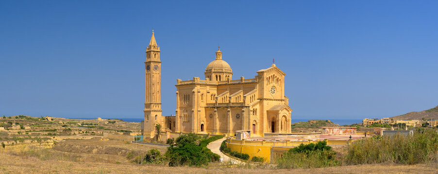 Panoramic view of Ta' Pinu Church on the island of Gozo in Malta with a beautiful blue sky.