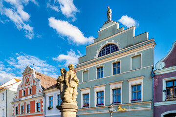 Summery city view with listed architecture and stone fountain on Cottbus market square