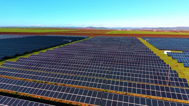 Modern solar panels organized in straight rows. Photovoltaic cells facing the sun accumulate energy.
