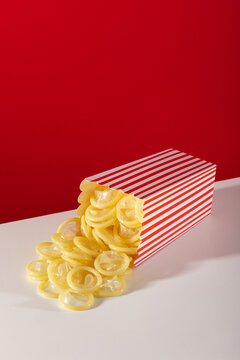 Creative concept with condoms in popcorn box