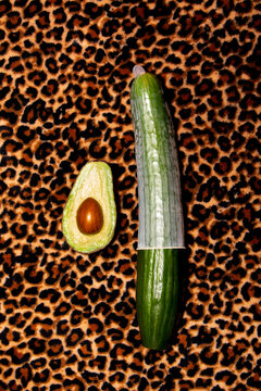 Cucumber with condom and avocado on leopard print