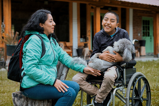 Smiling boy in wheelchair enjoying outdoor time