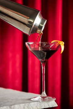 Elegant vermouth cocktail being poured into glass