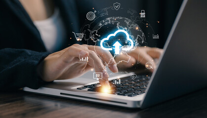 Business professional using laptop with cloud upload icon, representing cloud computing, data storage, cybersecurity, and digital transformation for modern online business and remote work solutions.