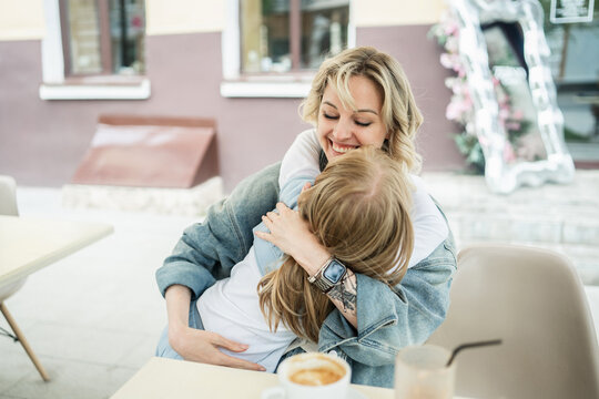 Mother and daughter enjoying time at a street cafe