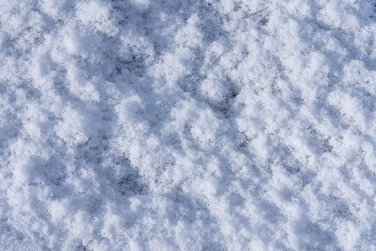 Close-up of fresh snow texture with soft shadows