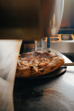 Artisan pizza baking in traditional Neapolitan pizzeria
