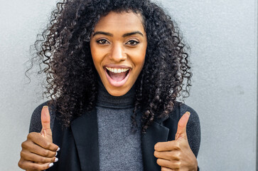 Woman giving thumbs up with joyful expression
