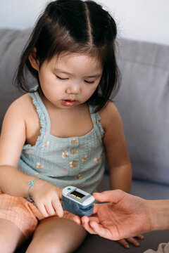 Child receives healthcare checkup using oximeter