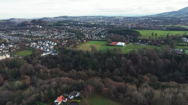 Aerial view of Edinburgh cityscape with the iconic Arthur's Seat mountain in the distance, Scotland