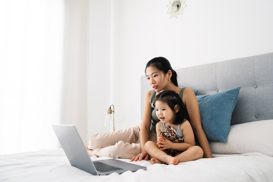 Mother and daughter enjoying time on a laptop