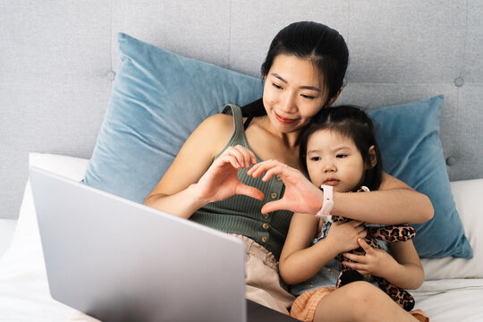 Mother and child bonding while watching a video together