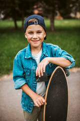 Young boy learning to ride longboard on street.