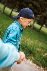 Young boy walking outdoors during springtime.