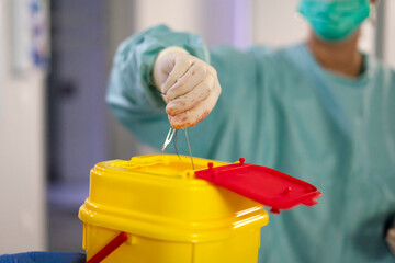 Female doctor disposes of medical waste in hospital