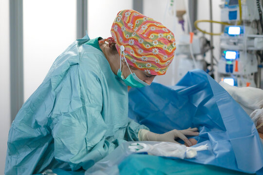 Female doctor inserting central line in hospital