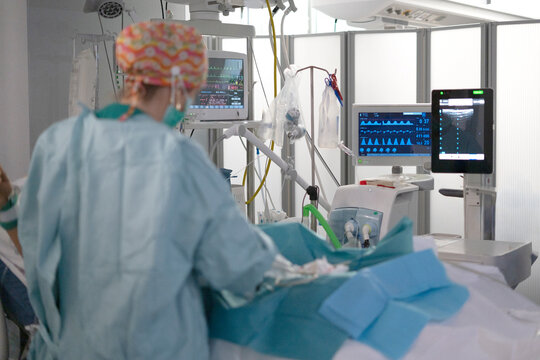 Female doctor inserting central line in hospital