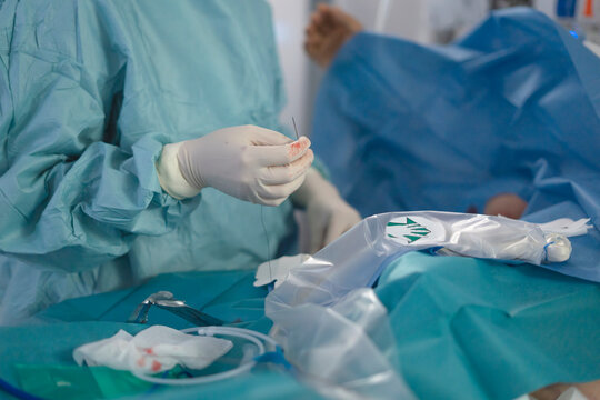 Female doctor inserting central line in hospital setting