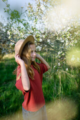 Girl enjoying spring blossoms in garden.