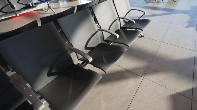 Empty seats in modern airport departure lounge.