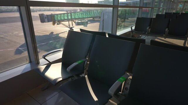 Empty seats in modern airport departure lounge.