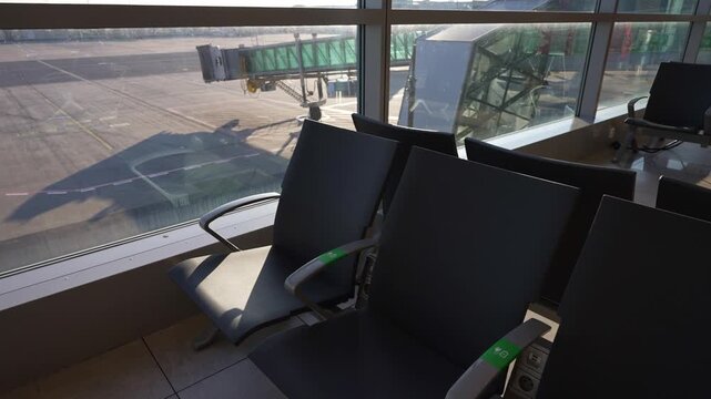 Empty seats in modern airport departure lounge.