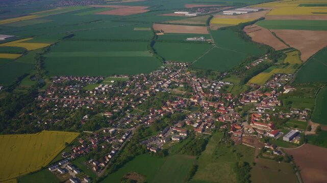 Aerial view of small village and farm fields.
