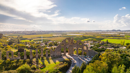 Naklejka premium Aspendos Aerial panoramic view of the Roman aqueduct that served the ancient city. Aqueducts in the land of Aspendos in Antalya. Aerial panoramic view of the Roman aqueduct that served the area of Ma