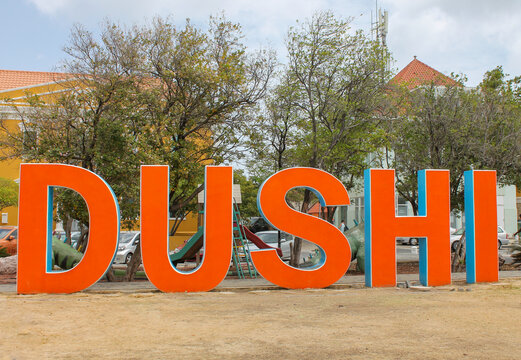 The iconic &ldquo;Dushi&rdquo; sign in bright orange letters located in Punda, Willemstad, Cura&ccedil;ao. A popular tourist attraction and photo spot symbolizing local language, Caribbean culture, and the warm welcome
