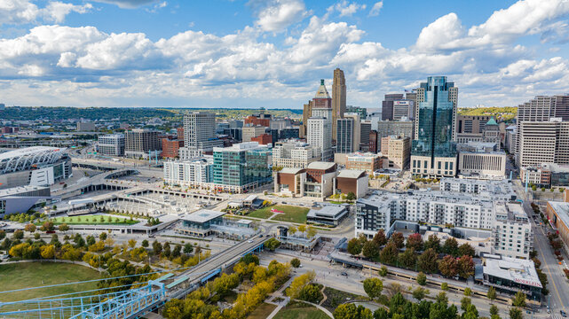 Aerial view of Cincinnati's skyline, where modern architecture meets vibrant green spaces under a vast sky, revealing a dynamic urban landscape., Cincinnati, Ohio, United States.